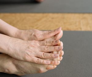 Close-up of feet on a yoga mat, showing balance.